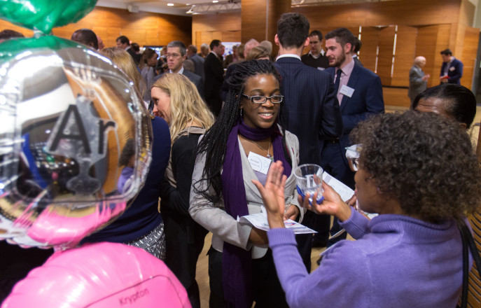 Donors stand by helium balloons at an event