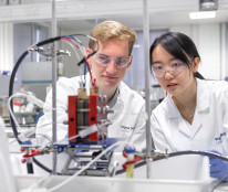 An image of two students doing research on new generation of batteries for energy storage