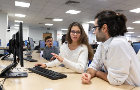 Female  student talking  to  male student whilst sitting down