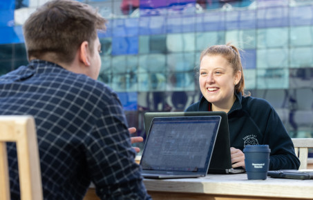An image of a student talking to a member of staff