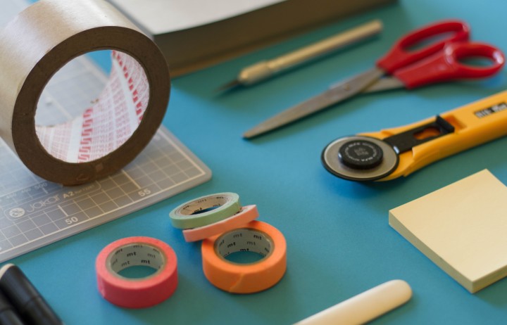 Office stationery including tape, scissors, postit notes