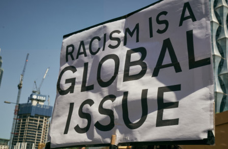Protest sign states Racism is a Global Issue