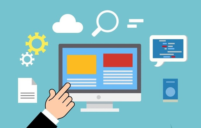 A hand pointing at a computer screen
