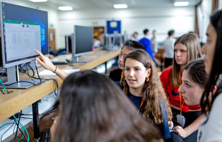 Group of students in front of a computer