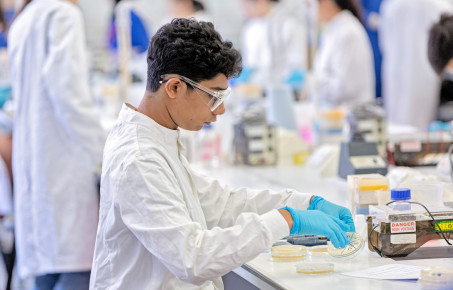 Student in lab with petri dish