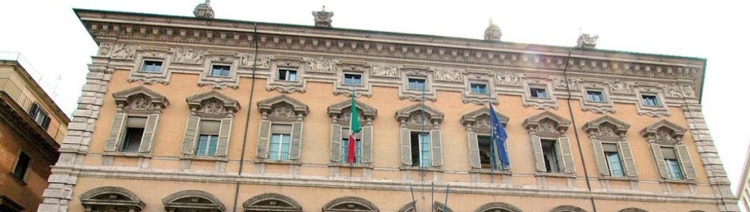 Photograph of a building with Italian and European flags