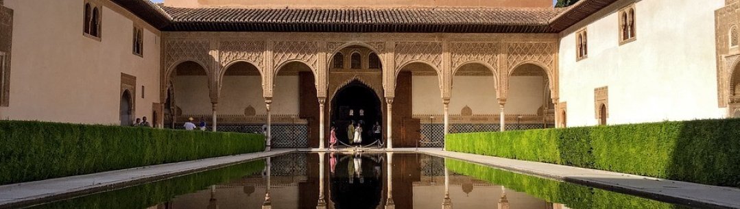Photograph of a building with Arabic flag