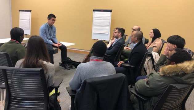 Students sit on chairs in a circle to be mentored during visit to BP Headquarters