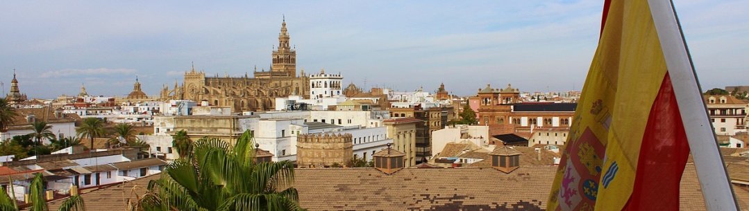 Photograph of a building with Spanish flag