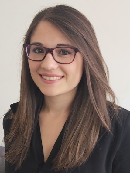 Woman in a black shirt wearing glasses